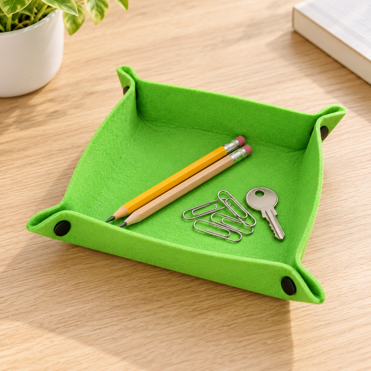 Felt tray holding pencils, paper clips and a key