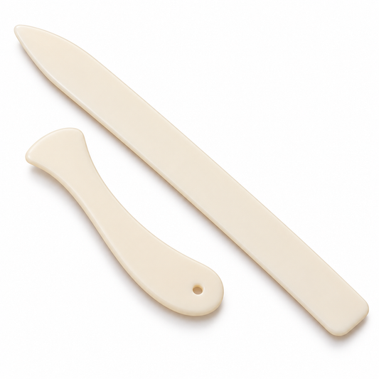 Two ivory plastic paper folding tools