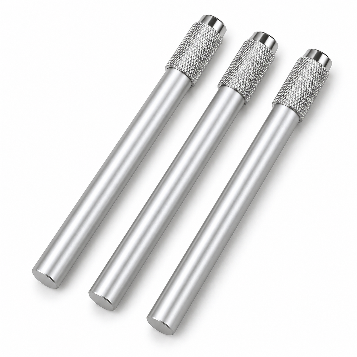 Three empty silver metal pencil extenders